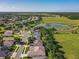 The aerial view showcases the neighborhood's proximity to a pond and open fields, offering scenic views at 25523 Maurepas Ln, Leesburg, FL 34748