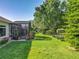 An amazing backyard with mature trees and a screened-in patio provides a serene and private outdoor space at 25523 Maurepas Ln, Leesburg, FL 34748