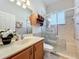Updated bathroom features a glass shower with built-in seating at 25523 Maurepas Ln, Leesburg, FL 34748