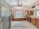 Large bathroom featuring tub with architectural columns, dual vanity, and walk-in shower at 25523 Maurepas Ln, Leesburg, FL 34748