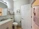 Well-maintained bathroom with a white vanity and subway tile walls at 25523 Maurepas Ln, Leesburg, FL 34748