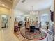 Elegant dining room featuring a round table, decorative rug, and a mirrored wall that enhances the space at 25523 Maurepas Ln, Leesburg, FL 34748
