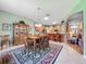 Open concept dining area with a hardwood dining set with nearby kitchen and living room at 25523 Maurepas Ln, Leesburg, FL 34748