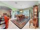 Open concept dining room that leads to a screened-in lanai and an adjacent living room at 25523 Maurepas Ln, Leesburg, FL 34748