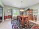 Traditional dining room featuring hardwood table set, hutch, and an area rug at 25523 Maurepas Ln, Leesburg, FL 34748