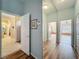 Inviting hallway offers seamless transition between rooms, complete with mirrored walls at 25523 Maurepas Ln, Leesburg, FL 34748