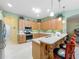 Kitchen featuring breakfast bar, stainless steel appliances, lots of counterspace and natural light at 25523 Maurepas Ln, Leesburg, FL 34748