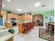 Kitchen with stainless appliances, breakfast bar, and lots of cabinet space that opens to living room at 25523 Maurepas Ln, Leesburg, FL 34748
