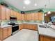 Kitchen featuring stainless steel appliances and light wood cabinets, and quartz counter tops at 25523 Maurepas Ln, Leesburg, FL 34748