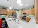 Kitchen with white quartz countertops, stainless steel appliances, and ample cabinet space at 25523 Maurepas Ln, Leesburg, FL 34748