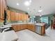 Updated kitchen featuring granite countertops, stainless steel appliances, and wood cabinetry at 25523 Maurepas Ln, Leesburg, FL 34748