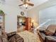 Comfortable living room with hardwood floors, leather chairs, ceiling fan and view of living area at 25523 Maurepas Ln, Leesburg, FL 34748