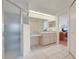 Functional bathroom featuring walk-in shower, vanity area, and tile flooring for a clean, practical design at 26736 Cash Ct, Leesburg, FL 34748