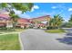 Elegant clubhouse entrance features covered drop-off, mature landscaping, and convenient parking at 26736 Cash Ct, Leesburg, FL 34748