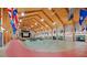 Spacious event space with high wood ceilings, stage, and ample seating, perfect for gatherings and celebrations at 26736 Cash Ct, Leesburg, FL 34748