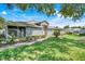 Charming home featuring a well-maintained lawn, beautiful light-gray siding, and a screened-in porch at 26736 Cash Ct, Leesburg, FL 34748