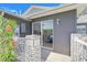 View of home showing outdoor patio area, sliding door, and gray siding for an inviting, modern look at 26736 Cash Ct, Leesburg, FL 34748