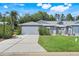 Charming single-story home featuring attached garage, well-maintained lawn, and welcoming curb appeal at 26736 Cash Ct, Leesburg, FL 34748