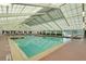 Bright indoor pool area featuring ample natural light, and comfortable seating at 26736 Cash Ct, Leesburg, FL 34748