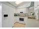 Bright kitchen featuring white cabinets, modern appliances, and tile flooring for a clean, updated look at 26736 Cash Ct, Leesburg, FL 34748