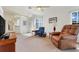 Spacious living room with plush chairs, high ceilings, neutral colors, and open concept design at 26736 Cash Ct, Leesburg, FL 34748