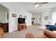 View of living room with neutral carpet, furnishings and view of the dining area at 26736 Cash Ct, Leesburg, FL 34748