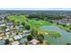 This aerial shot shows beautiful homes nestled beside a well-manicured golf course and a peaceful, picturesque pond at 3049 Saint Thomas Ln, The Villages, FL 32162