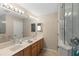 Bright bathroom featuring double sinks, an updated shower, and tile flooring at 3049 Saint Thomas Ln, The Villages, FL 32162