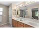 Bathroom featuring double sinks, modern vanity, and a well-lit mirror for added convenience at 3049 Saint Thomas Ln, The Villages, FL 32162