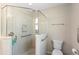 Accessible walk-in shower equipped with grab bars and marble-style walls for ease of use at 3049 Saint Thomas Ln, The Villages, FL 32162