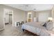 Bright bedroom with a ceiling fan, wood-look floors, and a large closet provides a relaxing retreat at 3049 Saint Thomas Ln, The Villages, FL 32162