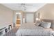 Bedroom features ceiling fan, natural light, en-suite bath, closet and geometric rug at 3049 Saint Thomas Ln, The Villages, FL 32162