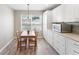 Charming dining area featuring modern light fixture, an adjacent window and ample cabinets at 3049 Saint Thomas Ln, The Villages, FL 32162
