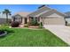 Charming single story home with a lush green lawn and manicured landscaping at 3049 Saint Thomas Ln, The Villages, FL 32162