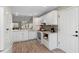 White kitchen with sleek cabinets and stainless appliances, open to living area at 3049 Saint Thomas Ln, The Villages, FL 32162