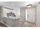 Open-concept kitchen features white cabinets and a breakfast bar, providing a seamless living space at 3049 Saint Thomas Ln, The Villages, FL 32162