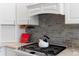 Close up of a modern kitchen featuring stainless steel appliances and a stylish backsplash at 3049 Saint Thomas Ln, The Villages, FL 32162