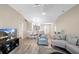 Living room featuring vaulted ceilings, natural light, and a smooth transition into the dining room at 3049 Saint Thomas Ln, The Villages, FL 32162
