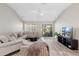 Living room with vaulted ceilings, neutral decor, and an open layout that connects to the kitchen at 3049 Saint Thomas Ln, The Villages, FL 32162