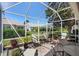 Inviting screened patio featuring ample seating and lush potted plants, ideal for relaxation at 3049 Saint Thomas Ln, The Villages, FL 32162