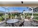 Relaxing screened lanai with comfortable seating area on brick flooring, perfect for outdoor entertaining at 3049 Saint Thomas Ln, The Villages, FL 32162