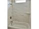 Modern bathroom showcasing a tub with marble tiled walls and a convenient shower niche at 3070 Sunscape Ter, Groveland, FL 34736