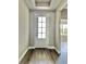 Bright entryway featuring hardwood floors and a stylish front door with glass panels at 3070 Sunscape Ter, Groveland, FL 34736