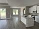 Open-concept kitchen with white cabinetry, stainless steel appliances, and center island at 3070 Sunscape Ter, Groveland, FL 34736