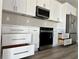 Modern kitchen with stainless steel appliances, new cabinets, and stainless steel hardware at 3070 Sunscape Ter, Groveland, FL 34736