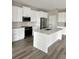 Bright kitchen with white cabinets, stainless steel appliances, and a large island perfect for entertaining at 3070 Sunscape Ter, Groveland, FL 34736