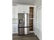 Kitchen featuring stainless steel refrigerator, custom cabinets, and a large pantry at 3070 Sunscape Ter, Groveland, FL 34736