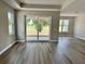 Bright living room featuring large windows and sliding door with a backyard view at 3070 Sunscape Ter, Groveland, FL 34736