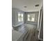 Living room features multiple windows with a view of the yard at 3070 Sunscape Ter, Groveland, FL 34736