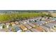 Scenic aerial view of a residential neighborhood with tree-lined streets and well-maintained single-Gathering homes at 312 Emmalee Pl, The Villages, FL 32162